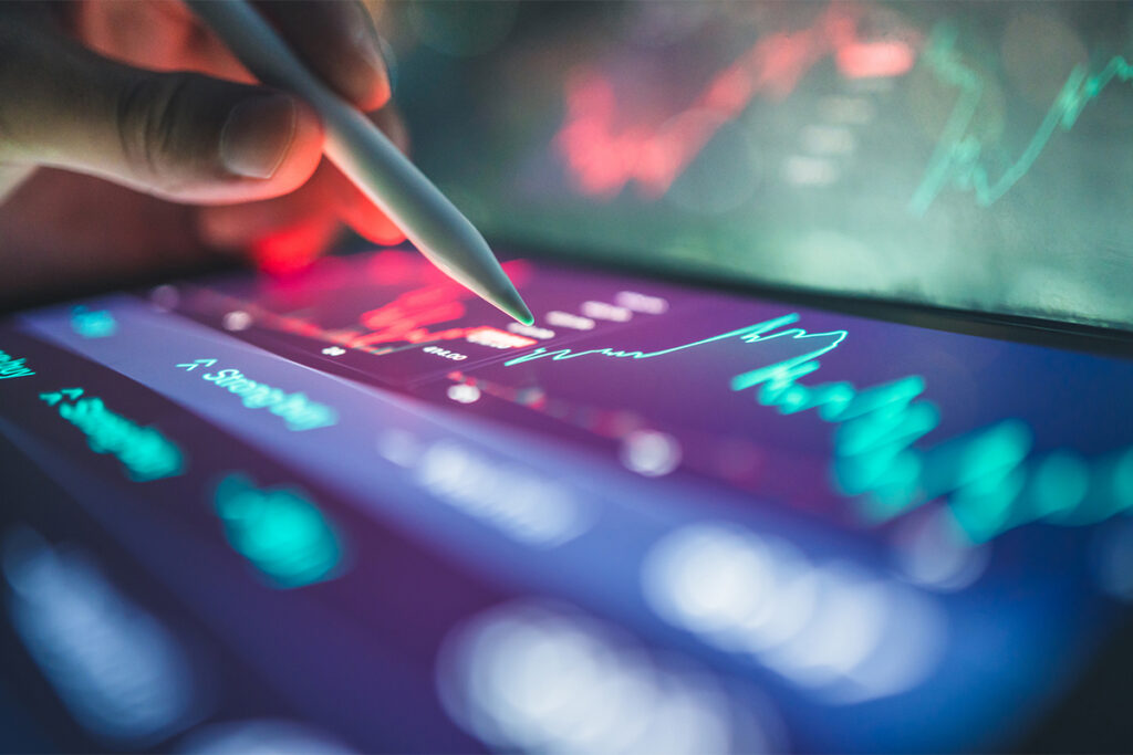 investor reviewing stock reports and financial dashboards on hybrid tablet laptop with AI digital finance workflow with business charts and online investment platforms